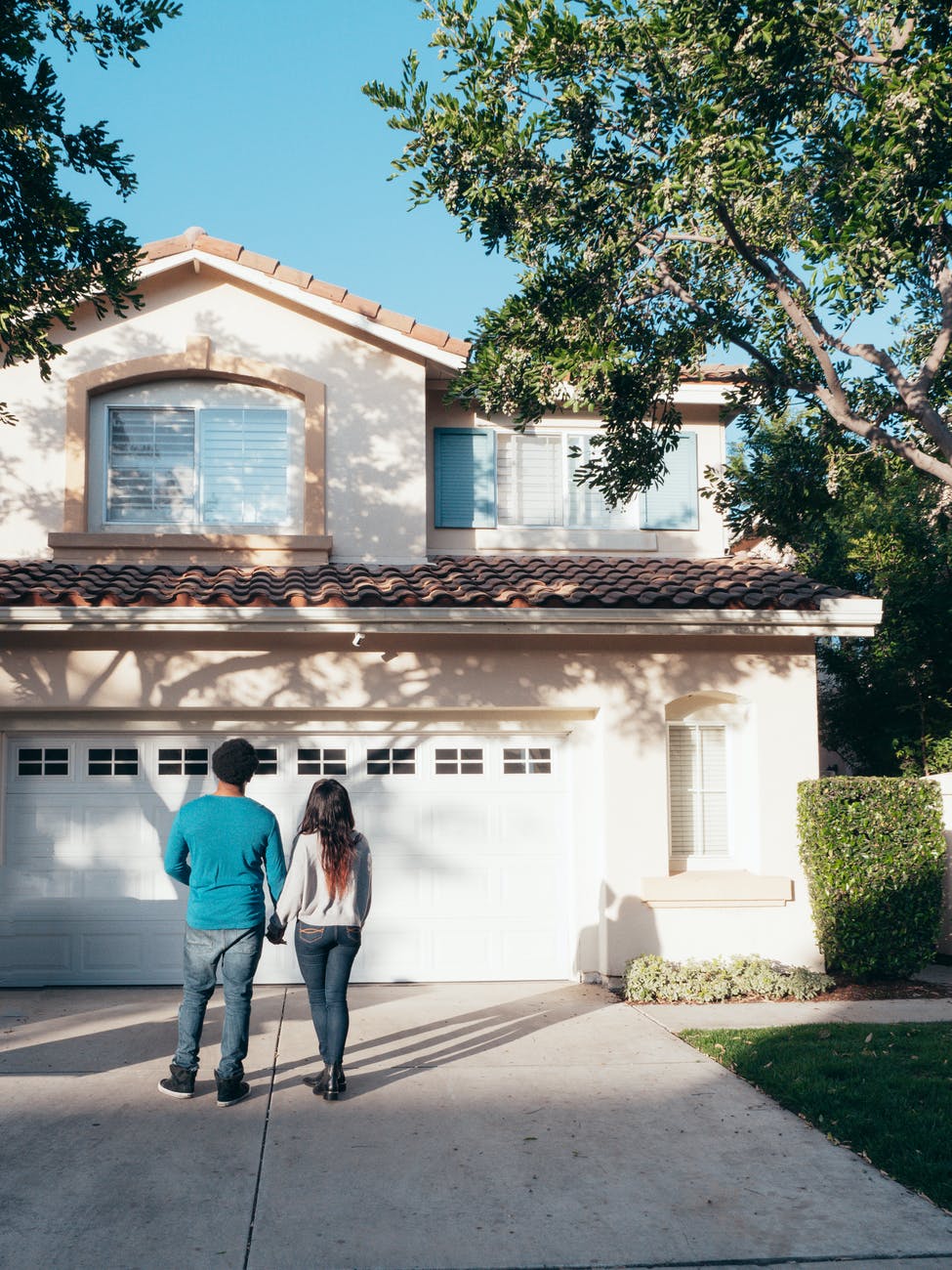 couple standing in front of their house